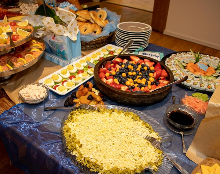  Kosher buffet table with fruit, boiled eggs, sushi and chopped herring 