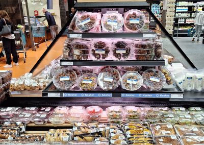 A section of Berkies Kosher Deli in Cape Town showing an array of sweet treats and salads