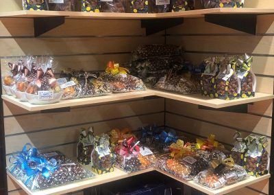 A shelf in store at Berkies Kosher Deli showing all the wrapped traditional jewish sweet treats